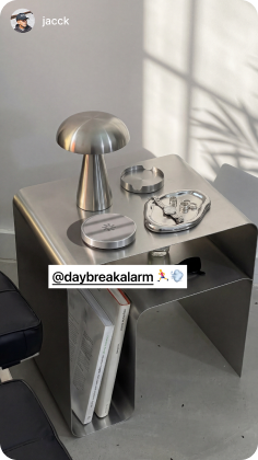Daybreak dock on a metal side table beside a lamp