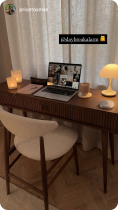 Daybreak dock on a desk beside a laptop and lamp
